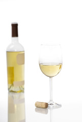 Glass of White Wine with Bottle in Background