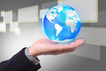 Business hand holding cystal globe on a touch screen background