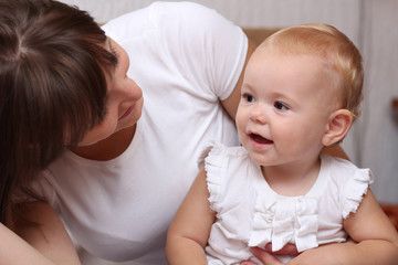 Adorable baby and mother in home