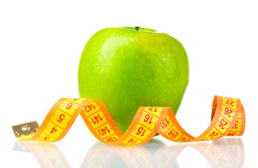 green apple and measuring tape isolated on white