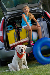 Girl with dog ready for travel for summer vacation