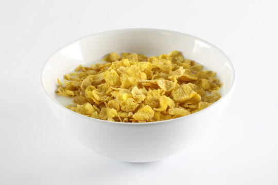 Bowl with corn flakes on the white background