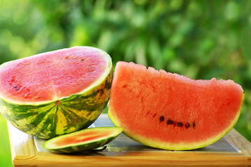 Watermelon and slice on table.
