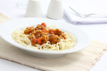 spaghetti with tomato sauce in white background