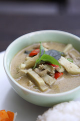 Thai food chicken green curry with rice in wood background