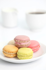 Colorful Macaron with coffee in close up isolated on white backg