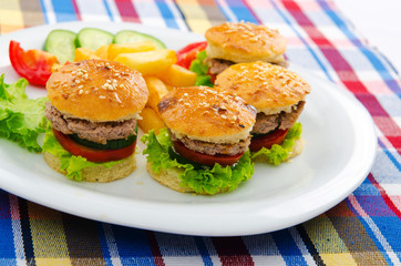 Plate with tasty mini burgers