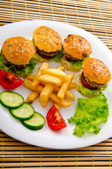 Burgers with french fries in plate