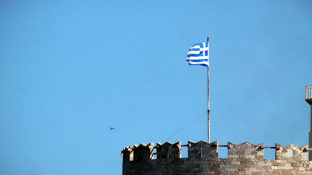 The national Greece flag on a sky background