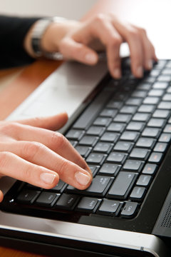 Woman hands typing on the laptop