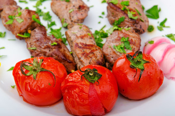 Kebab and tomatoes in the plate