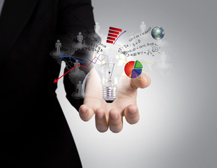 Business man holding light bulb in his hand