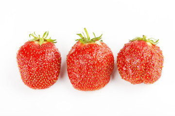 Three strawberries on a white background