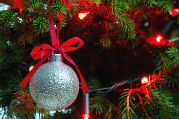 Christmas Ornament with Lighted Tree in Background, Copy Space