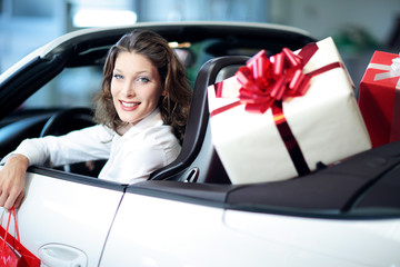 portrait of young woman, shopping,convertible car, gift box
