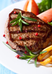 Closeup of grilled steak with french fries