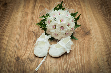 shoes and bouquet on a wooden floor