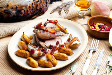 baked pheasant with bacon, pear, raisins on brandy