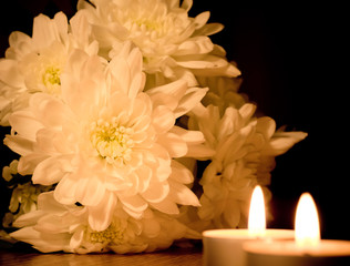 Beautiful white floweres  and two burning candles