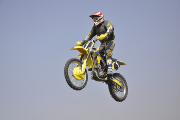 Motocross motorbike racer performs a jump efficient
