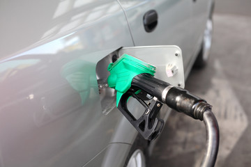 Filling car with fuel in a gas station, selective focus