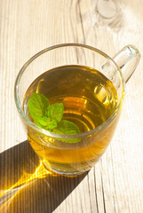 mint tea and mint leaf on old wooden table