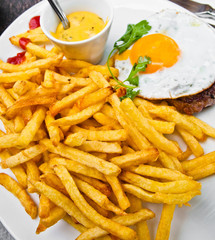 classical english breakfast with egg and fries