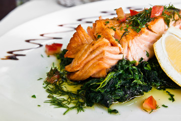 grilled salmon and lemon - french cuisine dish with tomato and s