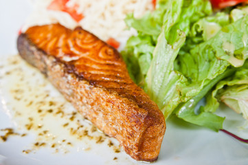 grilled salmon and lemon - french cuisine dish with tomato and s