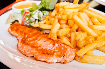 grilled salmon and lemon - french cuisine dish with tomato and s
