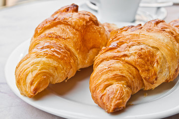 Breakfast with coffee and croissants