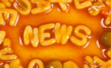 Pasta forming the word NEWS in tomato sauce