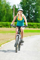 Young smiling woman on bike