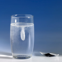 dissolving fizzy tablet in a glass of water