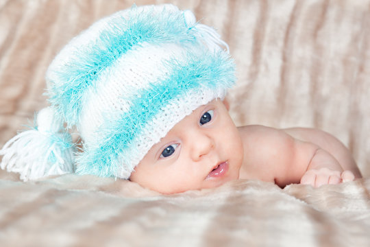 Bright portrait of adorable newborn baby in the cap