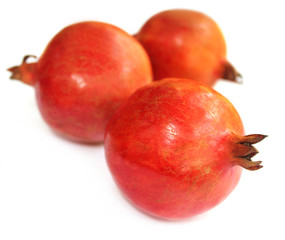Ripe pomegranate with oranges in selective focus
