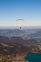 paragliding over lake and mountains in austrian Alps
