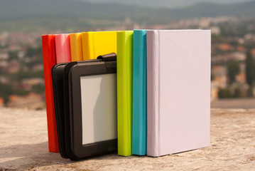 Row of colorful books with electronic book reader