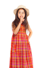 Little girl in straw showing silence sign