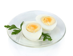 boiled eggs and parsley on a plate isolated on white
