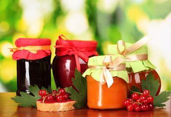 tasty berry and fruit jam and berry on a green background