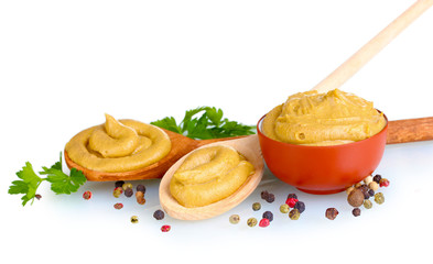 Mustard in bowl and spoons, spices and parsley isolated on white