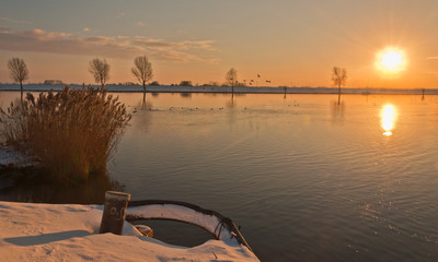 Sunset above a Dutch river in winter