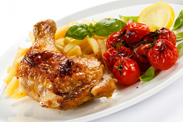 Grilled chicken leg, chips and vegetables