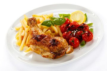Grilled chicken leg, chips and vegetables