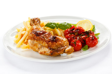 Grilled chicken leg, chips and vegetables