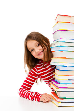 Girl peeking behind pile of books on white background