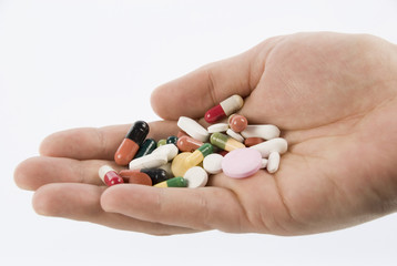 Cupped Hand Holding Mixture of Medical Pills