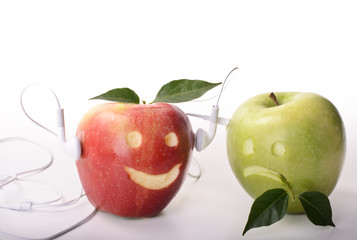 Green and red apple with headphone