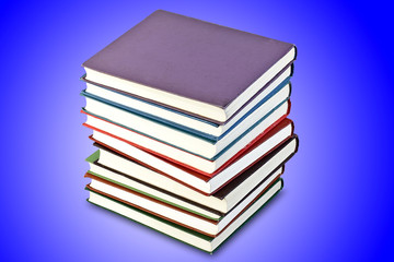 a stack of old books in the blue, isolated